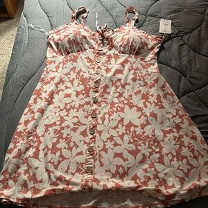 Cute coral colored summery dress. White floral print, padded bra liner, ruffles